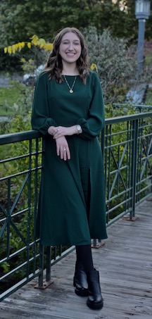 Madeline Scott, standing, wearing a green dress